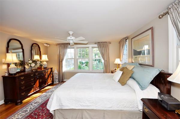 31 MacArthur Road Concord, MA 01742 - Photo 13 of 30 a spacious bedroom with a bed and wooden floor