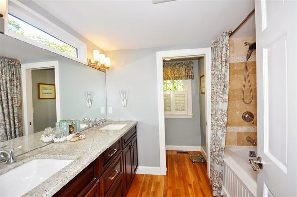 31 MacArthur Road Concord, MA 01742 - Photo 15 of 30 a bathroom with a granite countertop sink a mirror and a shower