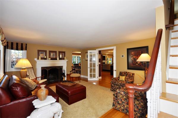 31 MacArthur Road Concord, MA 01742 - Photo 4 of 30 a living room with furniture a fireplace and a flat screen tv