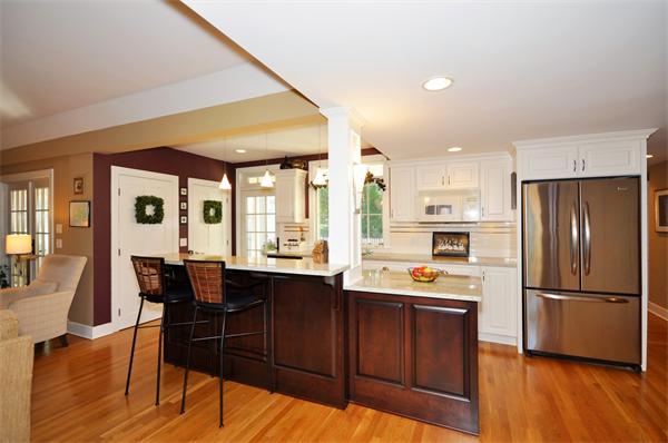 31 MacArthur Road Concord, MA 01742 - Photo 8 of 30 a kitchen view with stainless steel appliances granite countertop a refrigerator a sink dishwasher a dining table and chairs with wooden floor