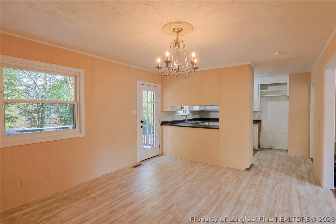 3315 Nato Road Fayetteville, NC 28306 - Photo 12 of 28 a view of a kitchen with wooden floor and stainless steel appliances
