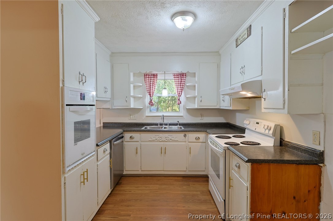 3315 Nato Road Fayetteville, NC 28306 - Photo 13 of 28 a kitchen with stainless steel appliances granite countertop a stove a sink and a refrigerator