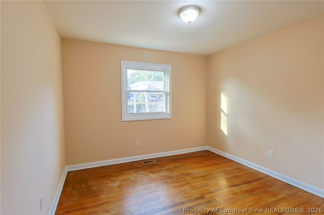 3315 Nato Road Fayetteville, NC 28306 - Photo 14 of 28 an empty room with wooden floor and windows
