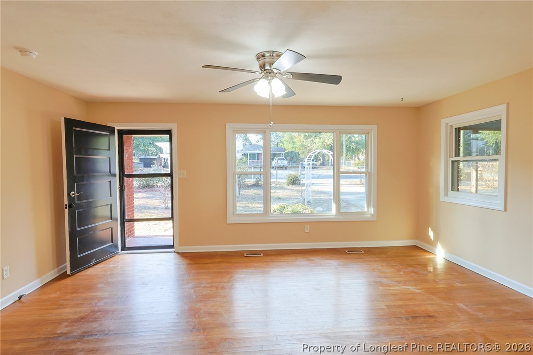 3315 Nato Road Fayetteville, NC 28306 - Photo 5 of 28 a view of an empty room with a window and wooden floor