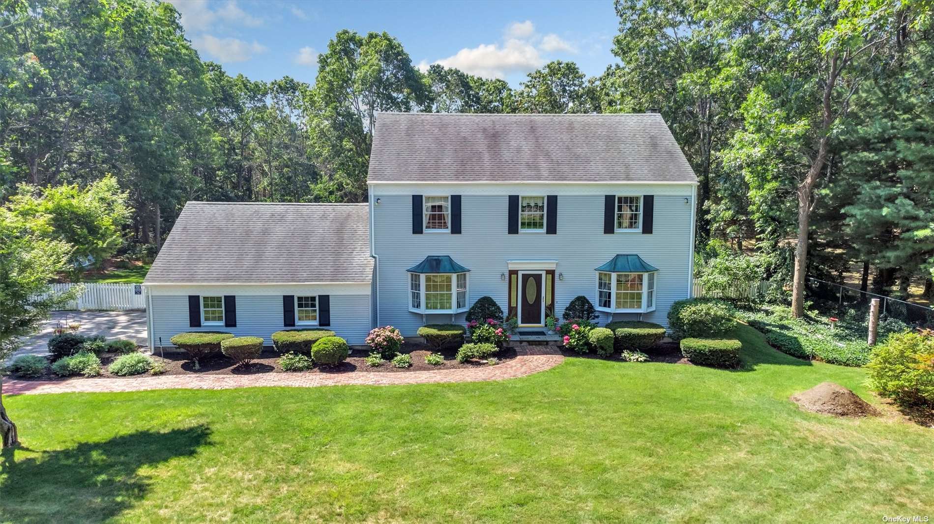 a aerial view of a house with table and chairs potted plants and a large tree