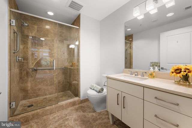 a big room with closet and a chandelier fan