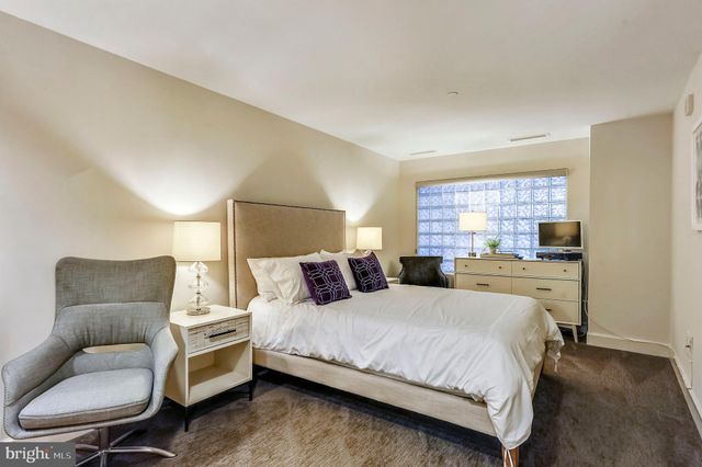 a view of a large building with a small yard and deck