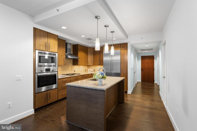 a kitchen with stainless steel appliances a sink stove and cabinets