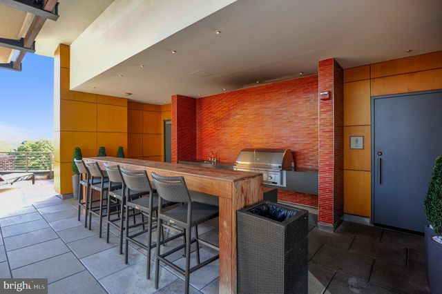 a view of a patio with table and chairs and potted plants