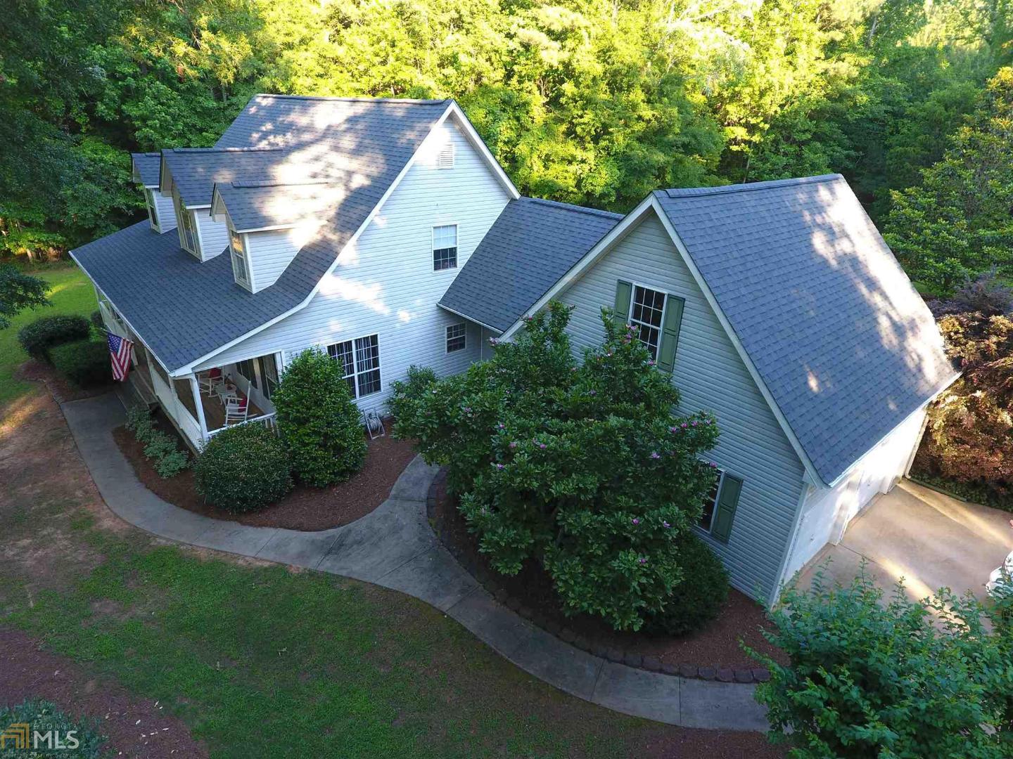 a aerial view of a house with a yard and potted plants