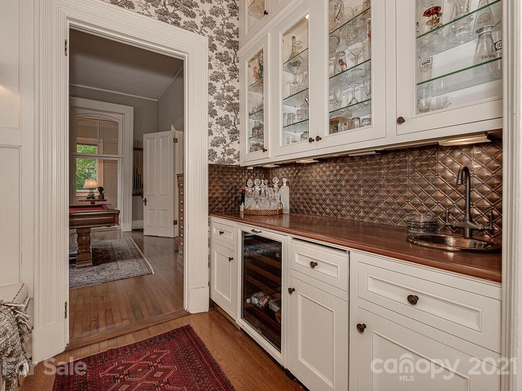 1700 Queens Road Charlotte, NC 28207 - Photo 17 of 48 a kitchen with white cabinets and sink