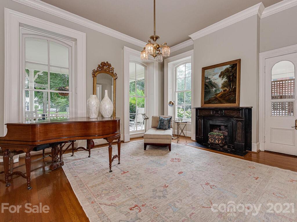 1700 Queens Road Charlotte, NC 28207 - Photo 18 of 48 a living room with furniture a fireplace and a chandelier