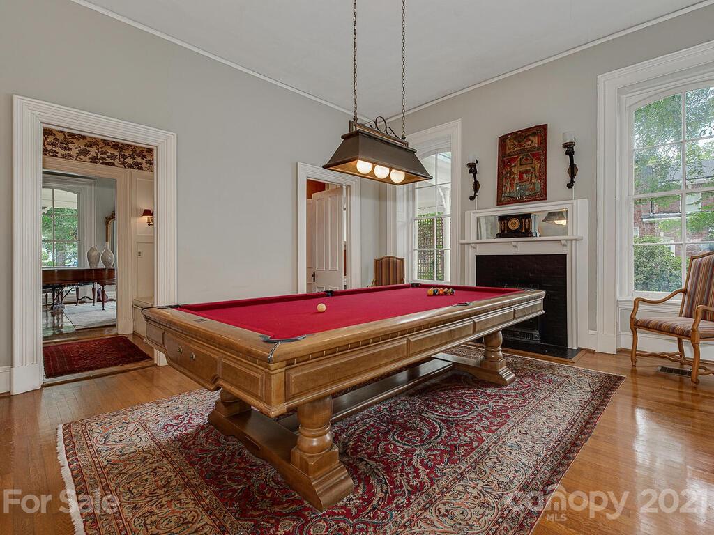 1700 Queens Road Charlotte, NC 28207 - Photo 21 of 48 a room with pool table table and paintings on the wall