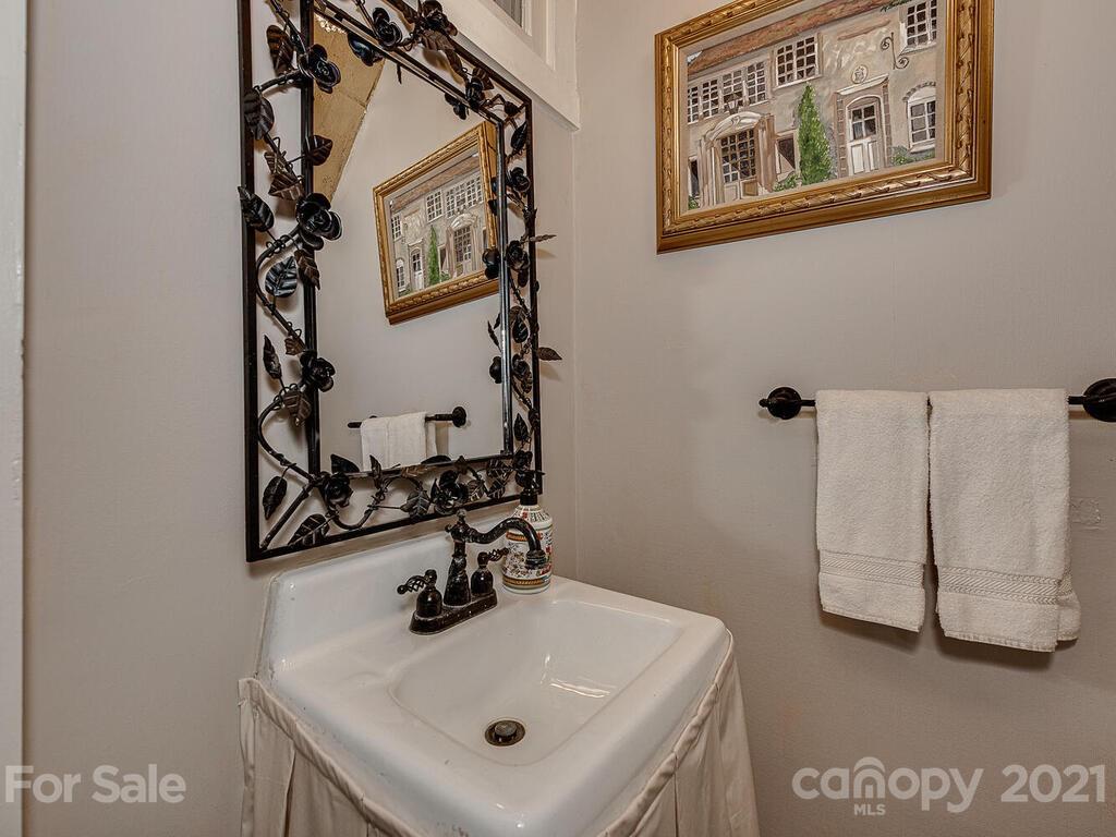 1700 Queens Road Charlotte, NC 28207 - Photo 25 of 48 a bathroom with a sink and mirror