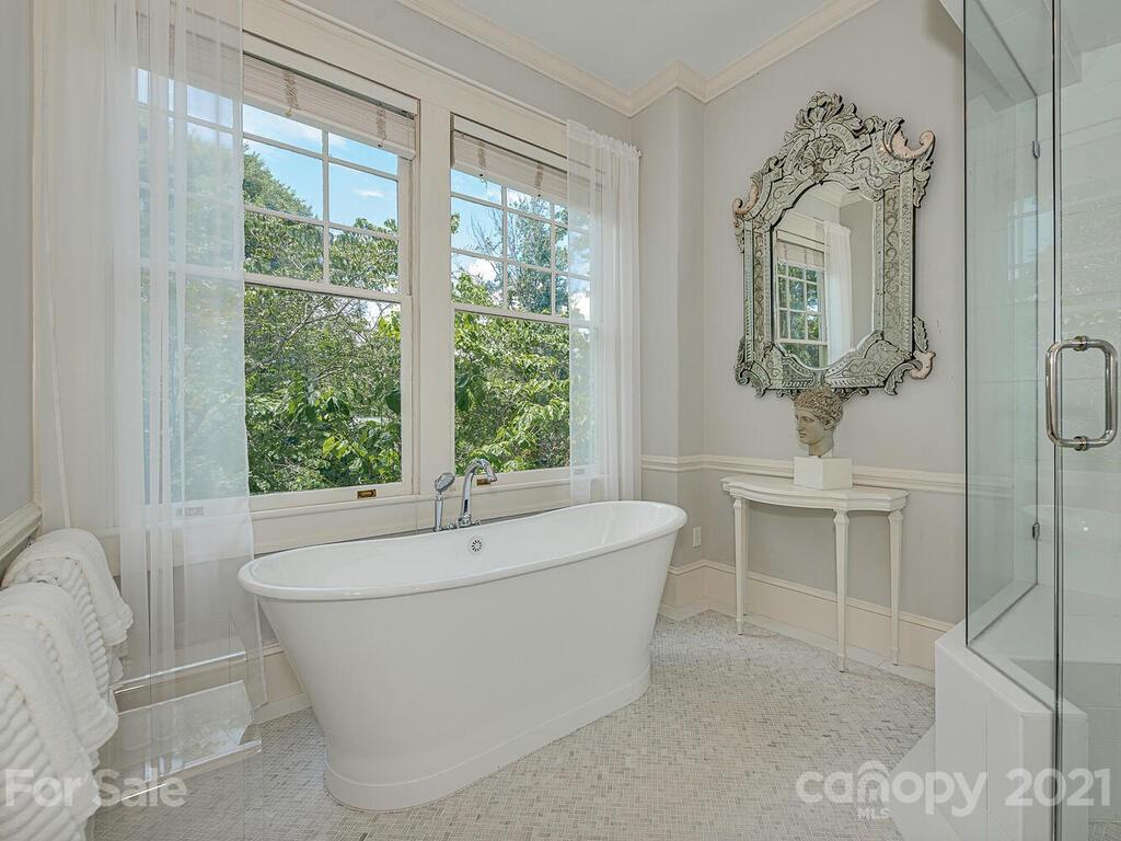 1700 Queens Road Charlotte, NC 28207 - Photo 30 of 48 a bath tub sitting in a bathroom next to a window
