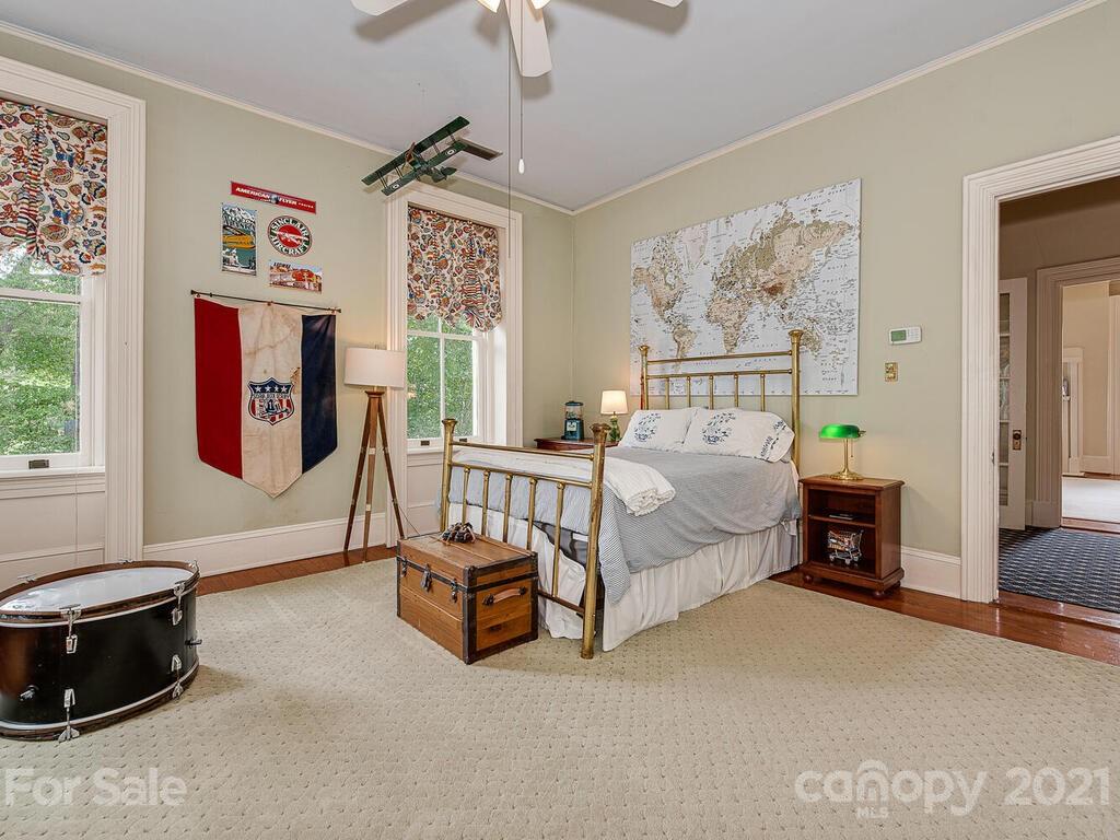 1700 Queens Road Charlotte, NC 28207 - Photo 36 of 48 a spacious bedroom with a bed a couch and a window