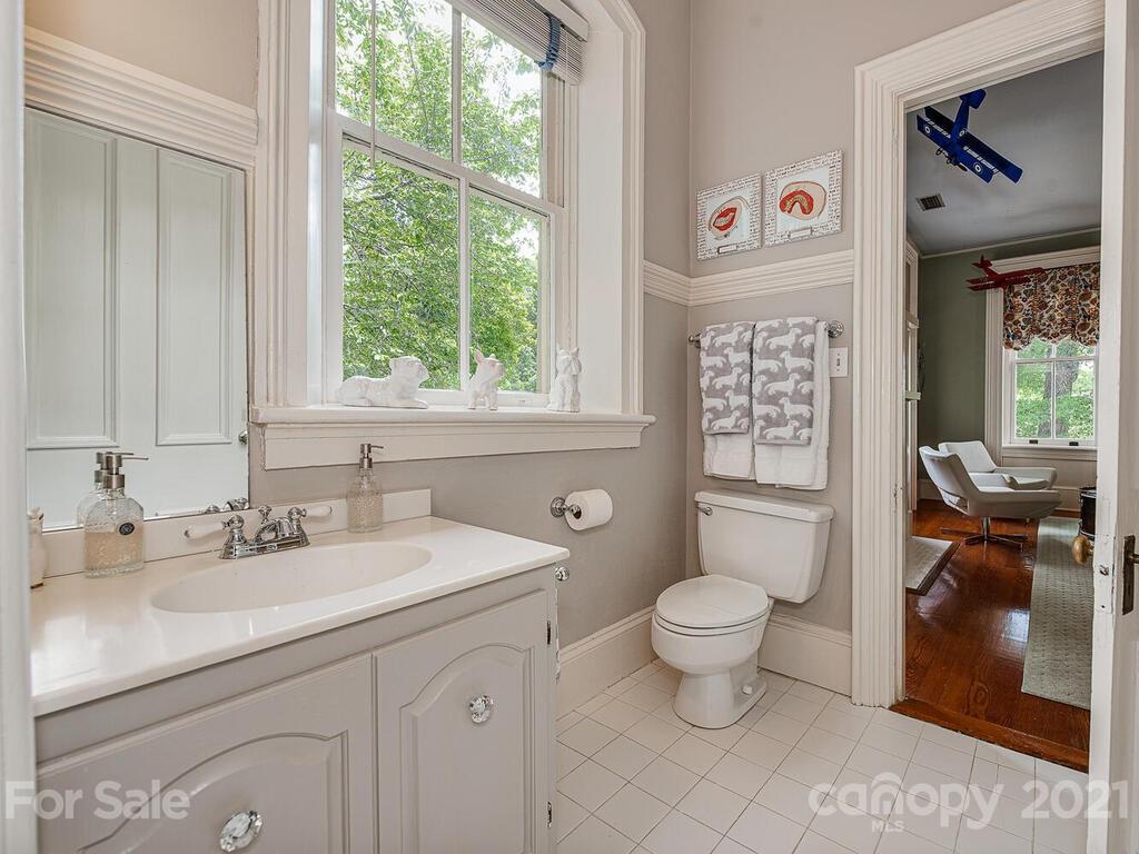 1700 Queens Road Charlotte, NC 28207 - Photo 37 of 48 a bathroom with a sink toilet and a window