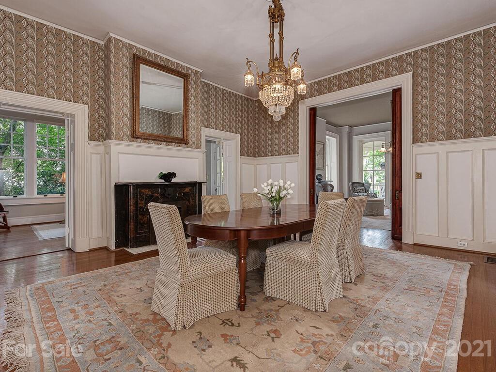 1700 Queens Road Charlotte, NC 28207 - Photo 9 of 48 a view of a dining room with furniture a chandelier and wooden floor