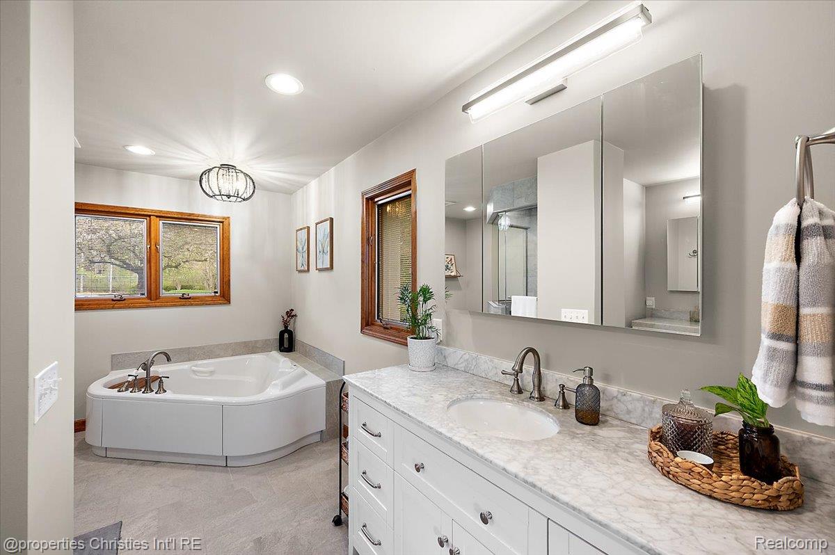 1071 Woodbridge Lane Rochester, MI 48306 - Photo 26 of 76 Full bathroom with vanity, a garden tub, and recessed lighting