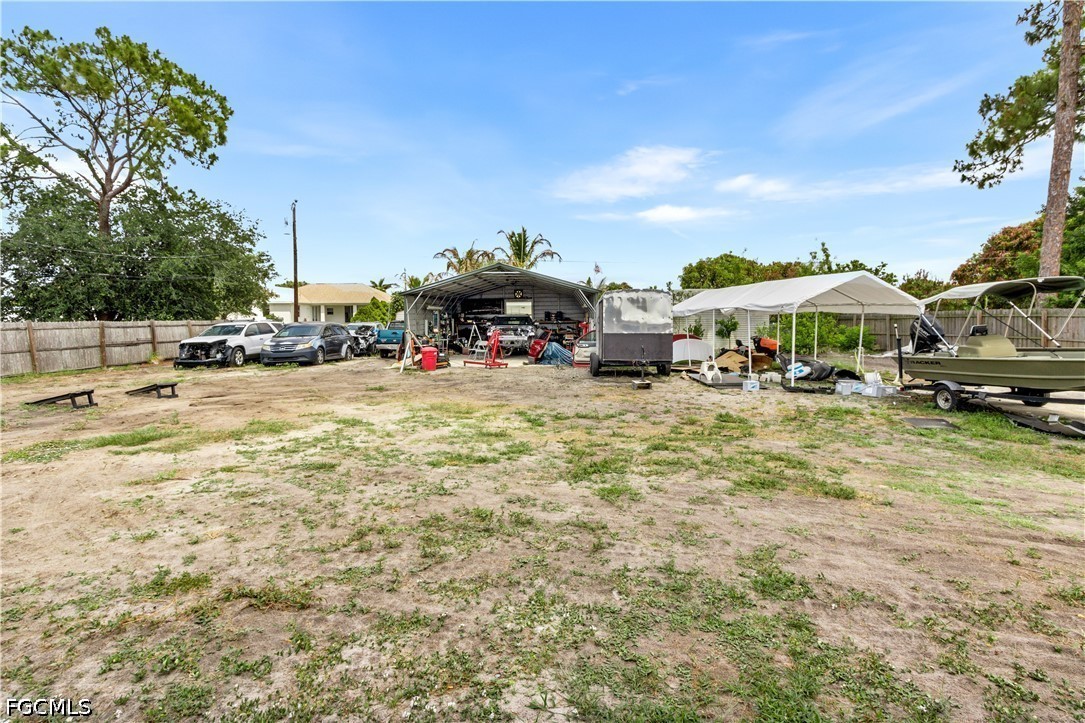 18 Illinois Road Lehigh Acres, FL 33936 - Photo 34 of 45 a view of a water with table and chairs under an umbrella