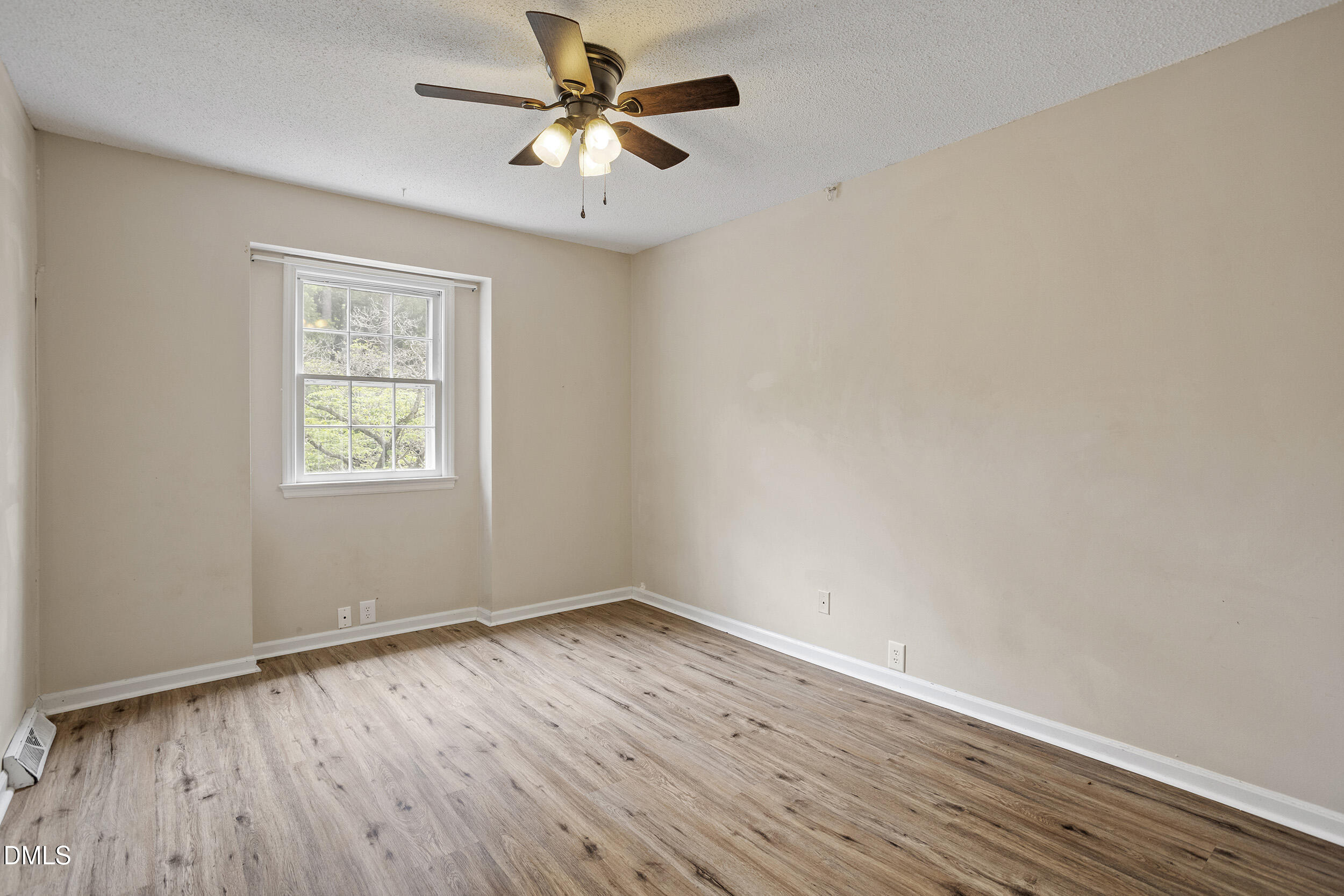 1801 Quail Ridge Road Raleigh, NC 27609 - Photo 20 of 29 an empty room with wooden floor fan and windows