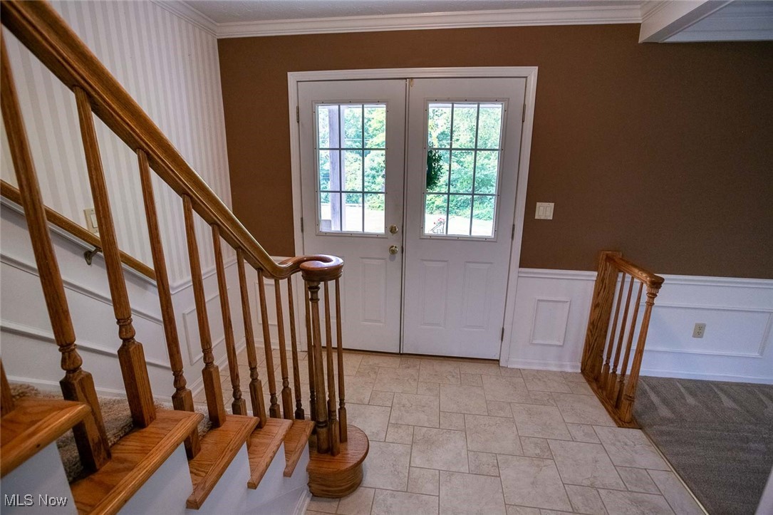 9046 River Styx Road Wadsworth, OH 44281 - Photo 12 of 30 Entryway with crown molding, french doors, and light tile patterned floors