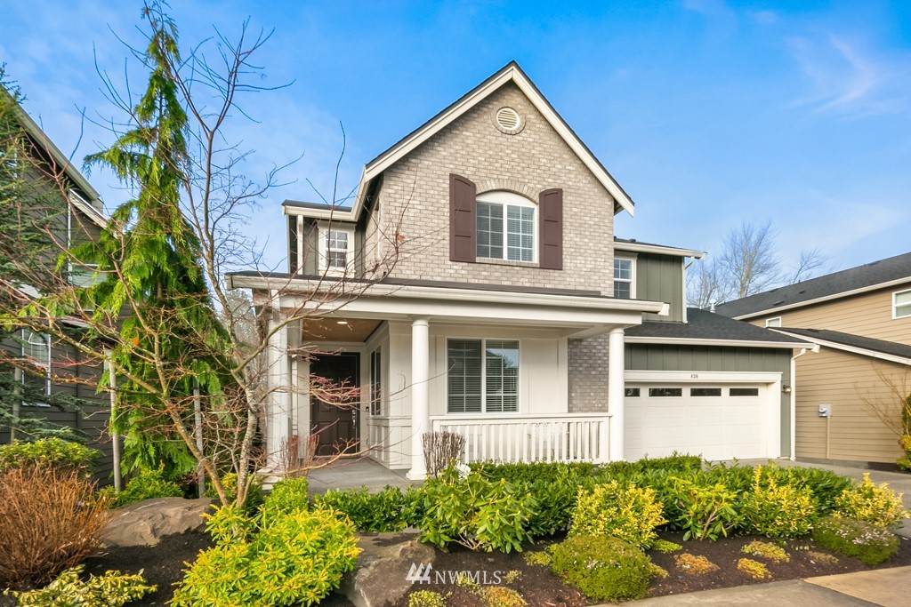 839 Lyons Avenue Northeast Renton, WA 98059 - Photo 1 of 39 a view of a white house with large windows and flower plants
