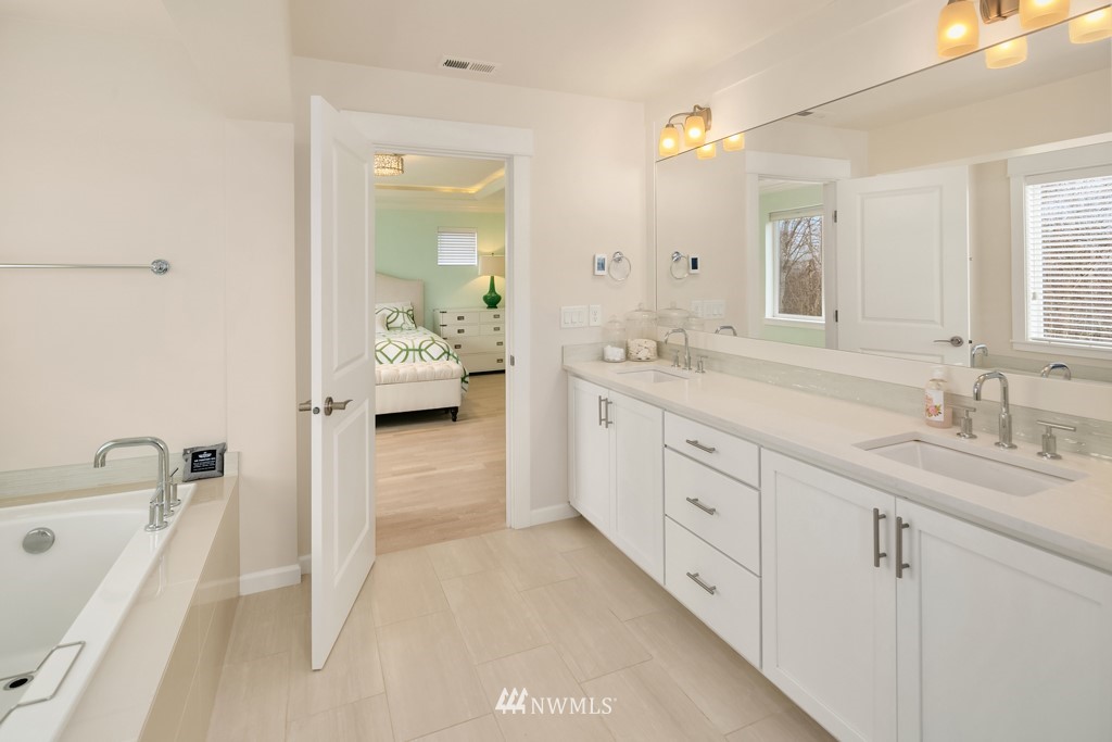 839 Lyons Avenue Northeast Renton, WA 98059 - Photo 31 of 39 a spacious bathroom with a granite countertop sink mirror and bathtub