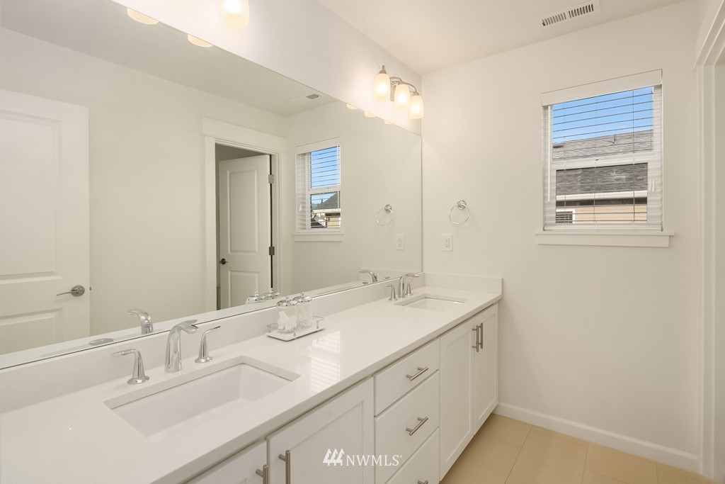 839 Lyons Avenue Northeast Renton, WA 98059 - Photo 33 of 39 a bathroom with a sink double vanity and a mirror