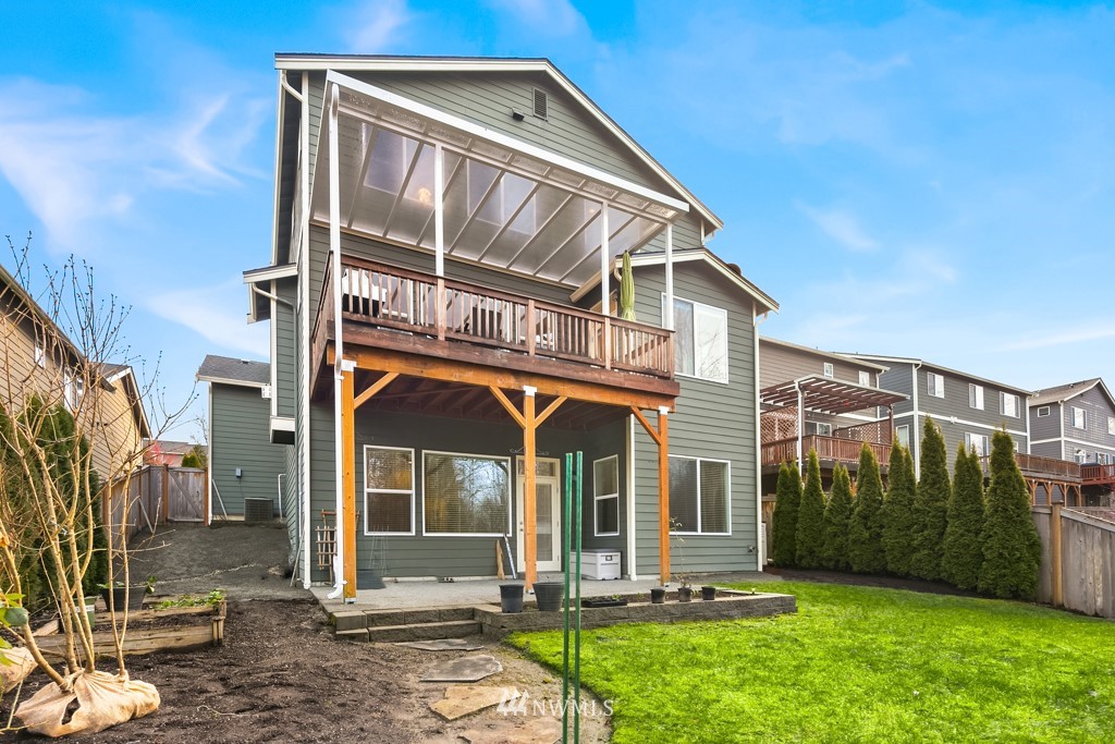839 Lyons Avenue Northeast Renton, WA 98059 - Photo 36 of 39 a view of a house with a small yard and floor to ceiling window