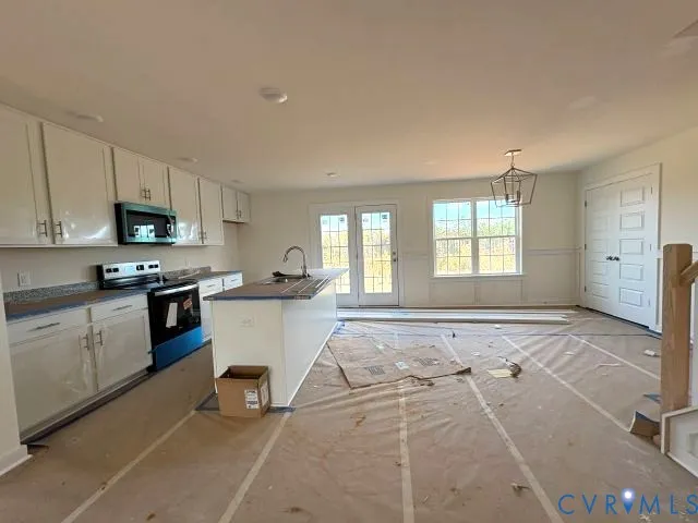 a kitchen with a stove a sink dishwasher and a refrigerator