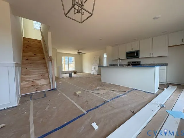 a view of a kitchen with a sink and cabinets