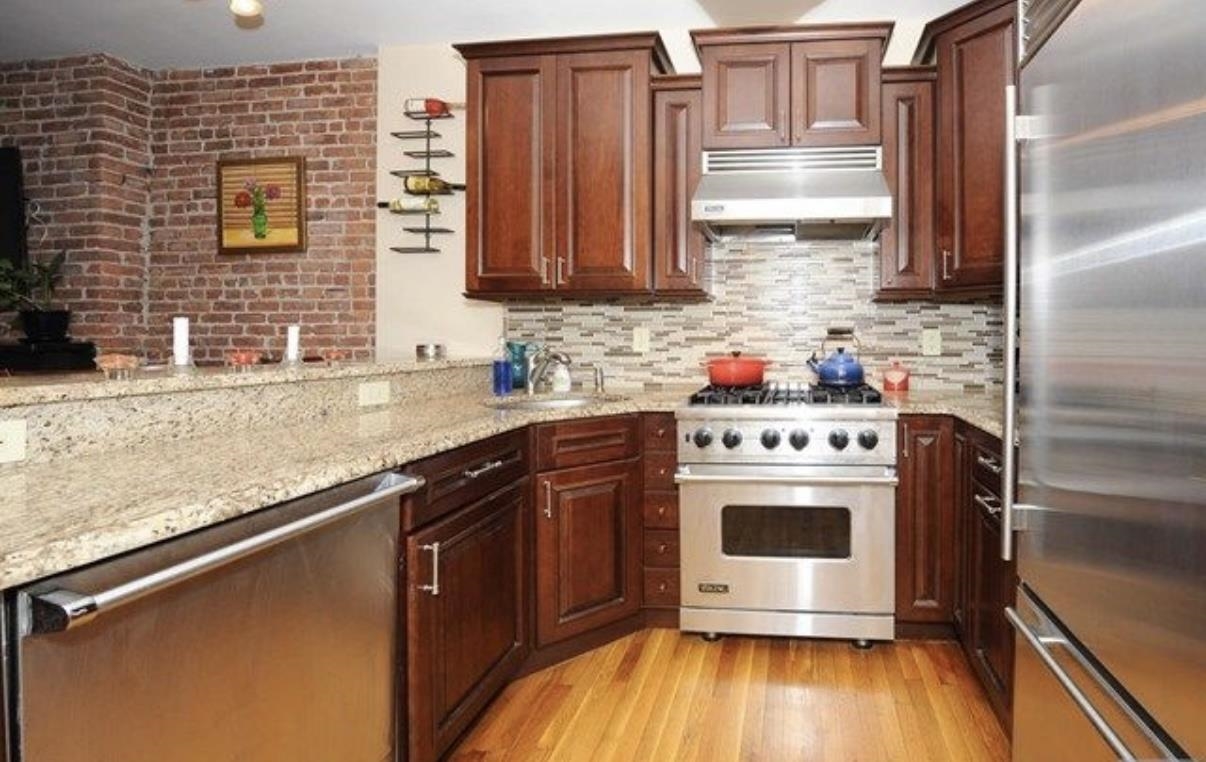 211 14th Street, Unit 2R Hoboken, NJ 07030 - Photo 3 of 10 a kitchen with stainless steel appliances a stove a sink and a microwave