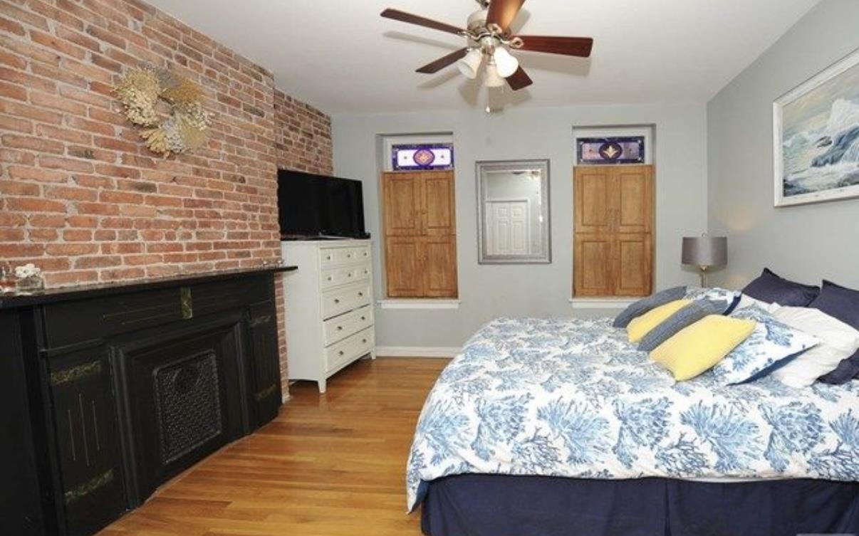 211 14th Street, Unit 2R Hoboken, NJ 07030 - Photo 5 of 10 a bedroom with a bed and a flat screen tv