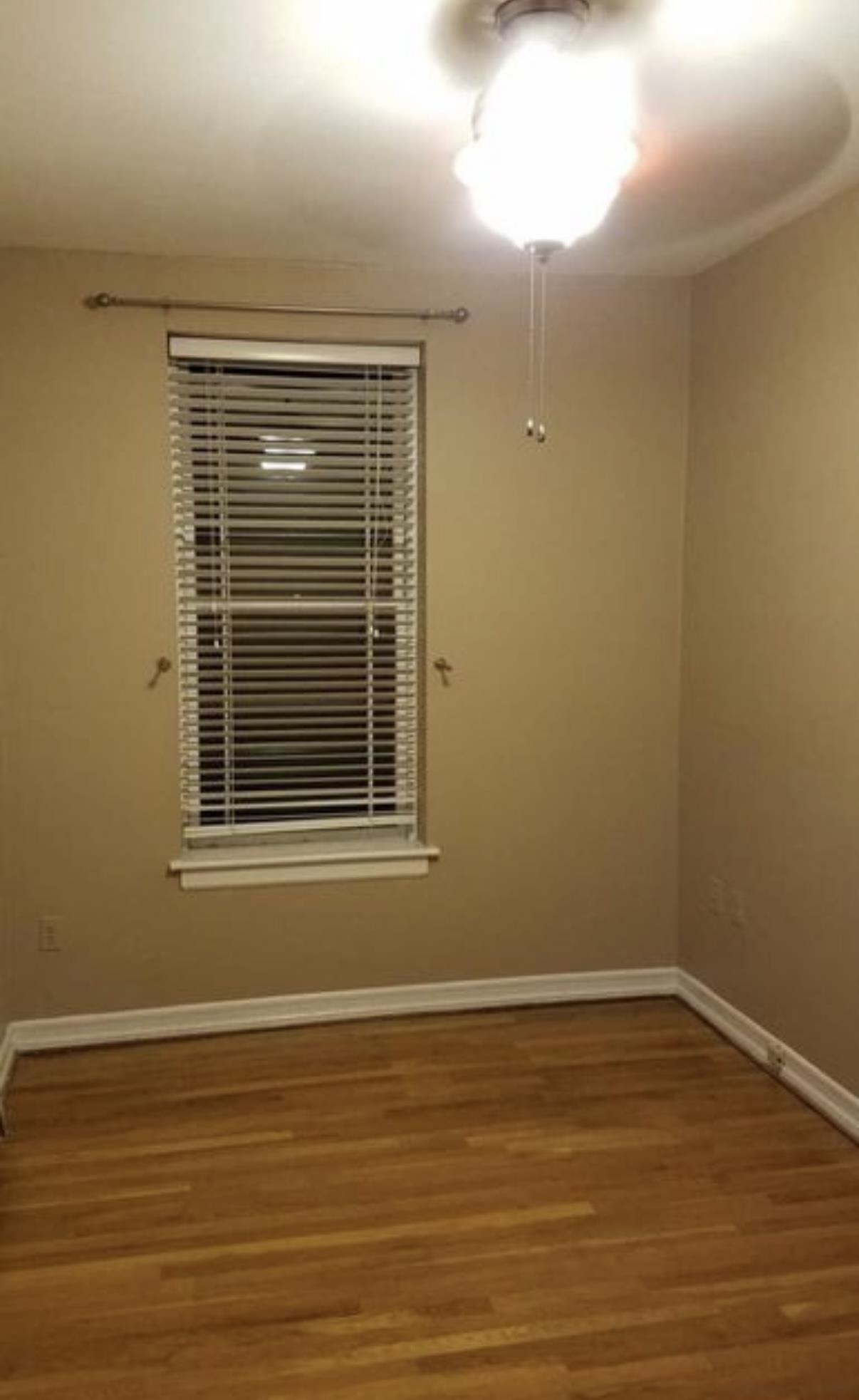 211 14th Street, Unit 2R Hoboken, NJ 07030 - Photo 6 of 10 a view of an empty room with wooden floor and a window