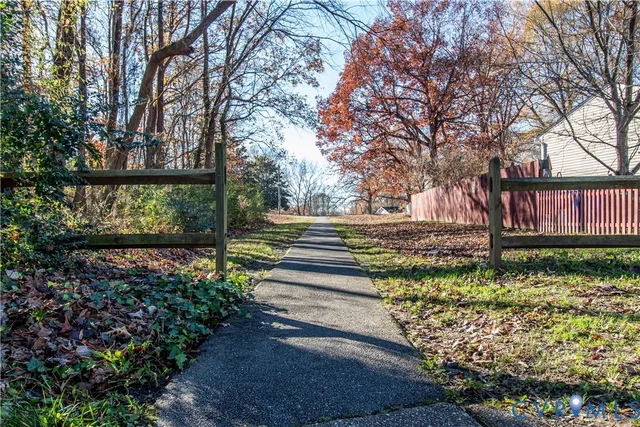 a front view of a house with a yard and garden