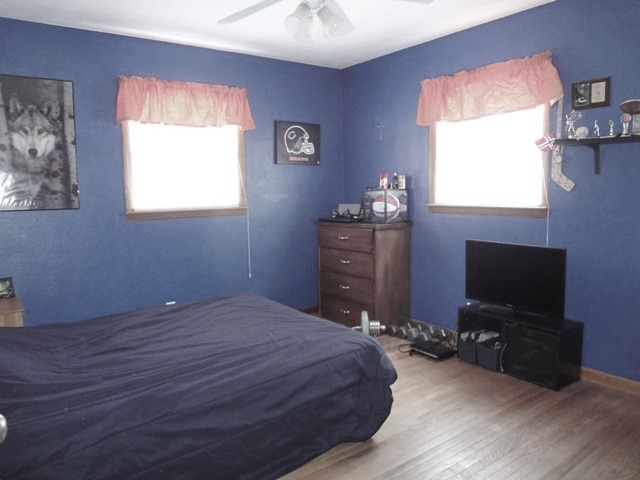 12920 Base Line Road Kingston, IL 60145 - Photo 16 of 25 a bedroom with a bed and a flat screen tv