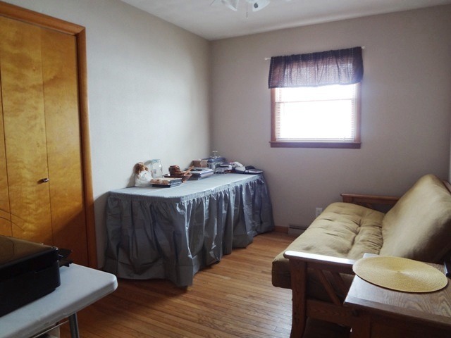 12920 Base Line Road Kingston, IL 60145 - Photo 17 of 25 a bedroom with a bed and wooden floor