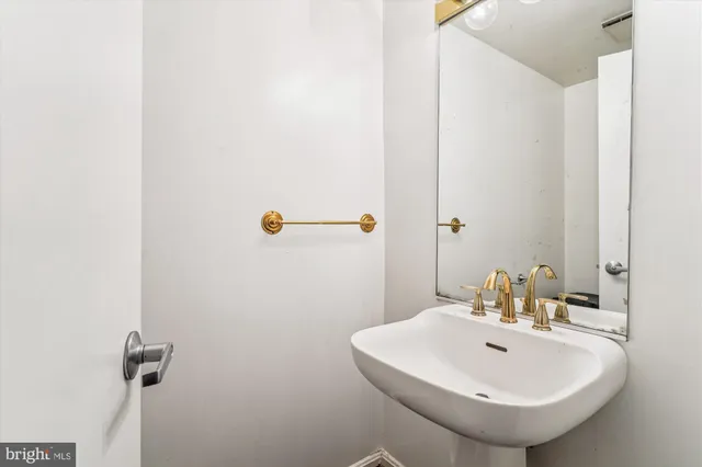 a bathroom with a sink and mirror