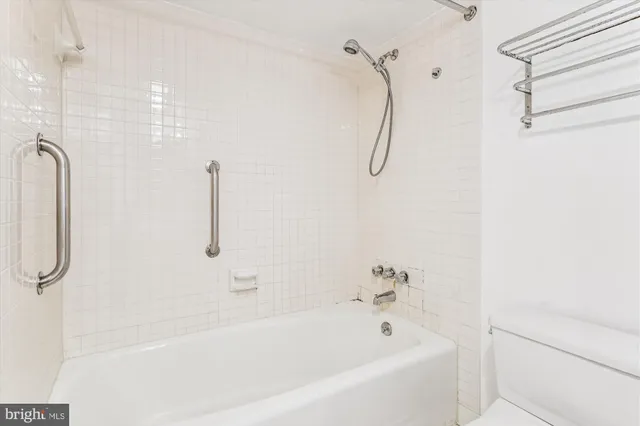 a bathroom with a bath tub with a shower