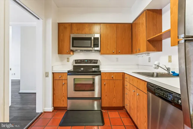 a kitchen with a sink stove and microwave