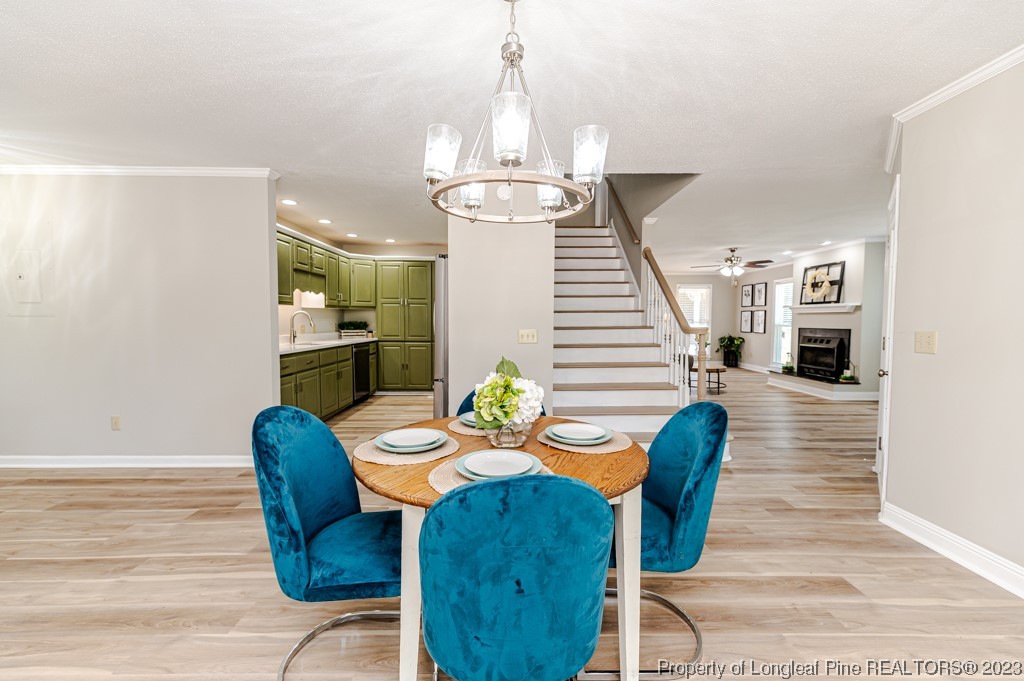 4286 Nicholson Road Cameron, NC 28326 - Photo 19 of 50 a view of a dining room with furniture wooden floor and chandelier