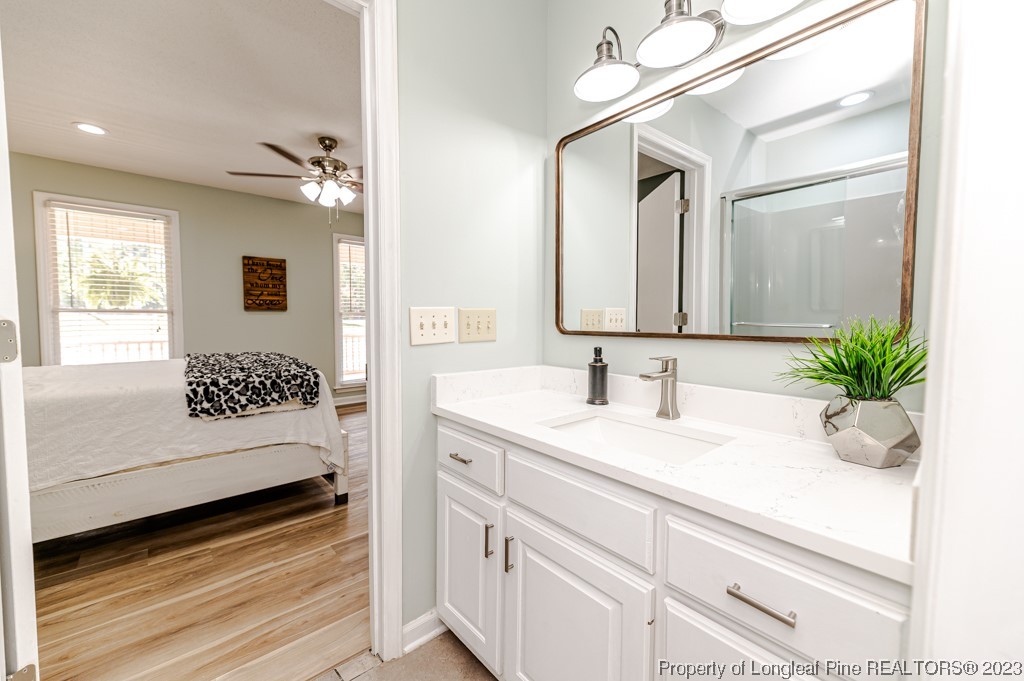 4286 Nicholson Road Cameron, NC 28326 - Photo 21 of 50 a en suite bathroom with a double vanity sink and a mirror