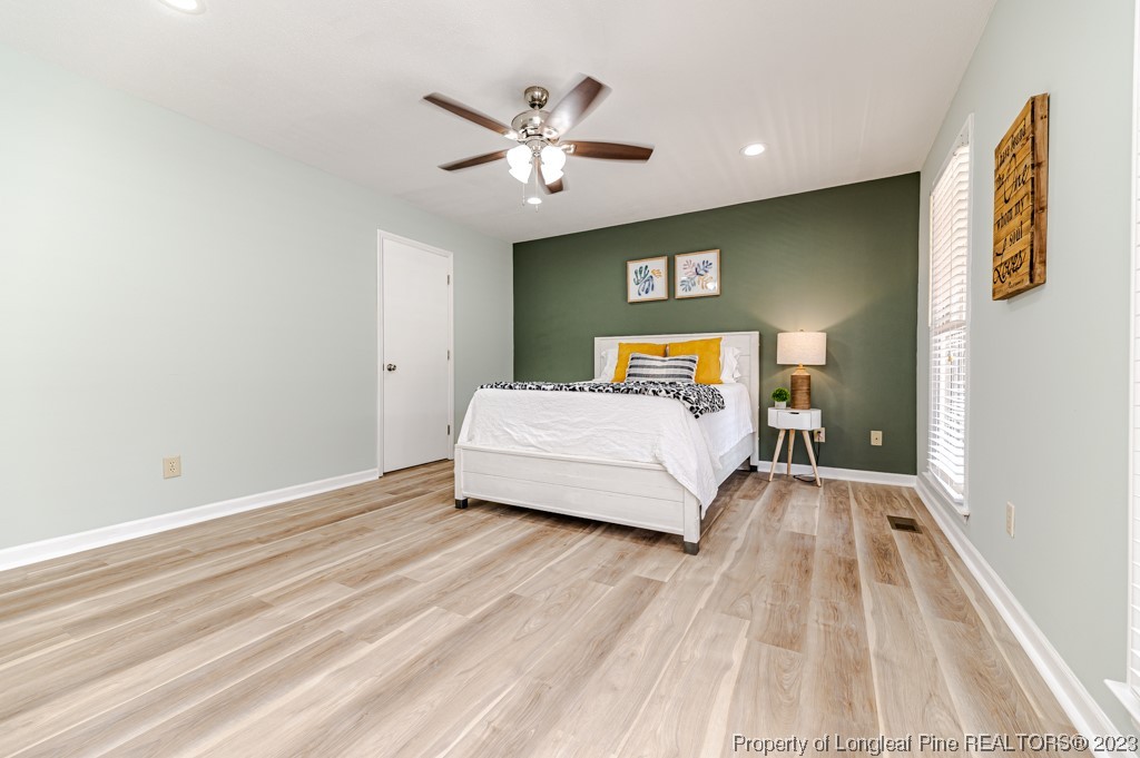 4286 Nicholson Road Cameron, NC 28326 - Photo 27 of 50 a bedroom with a bed and a chandelier