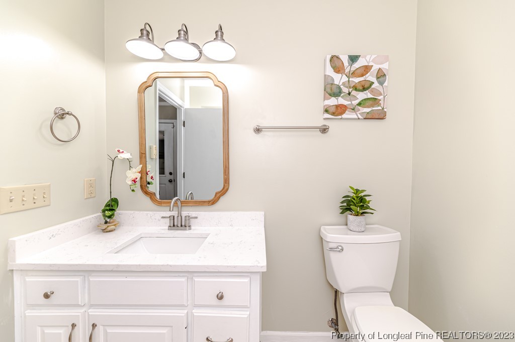 4286 Nicholson Road Cameron, NC 28326 - Photo 32 of 50 a bathroom with a toilet sink and mirror