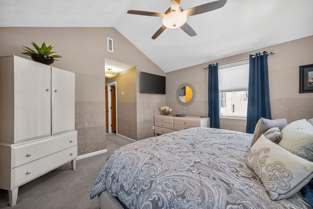 22 McRayne Hill Road Billerica, MA 01821 - Photo 17 of 42 a bedroom with a bed and a chandelier
