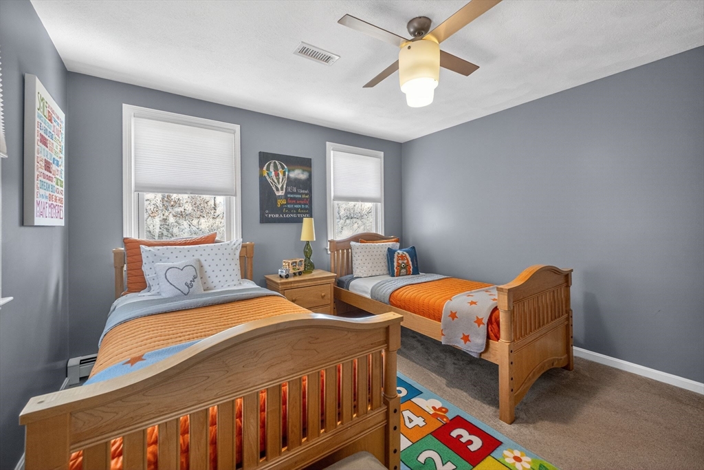 22 McRayne Hill Road Billerica, MA 01821 - Photo 19 of 42 a bedroom with two beds and a chandelier