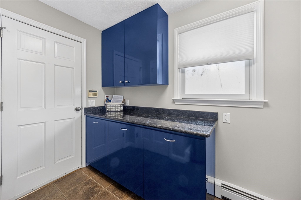 22 McRayne Hill Road Billerica, MA 01821 - Photo 20 of 42 a kitchen with granite countertop cabinets and sink
