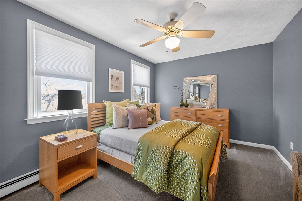 22 McRayne Hill Road Billerica, MA 01821 - Photo 29 of 42 a bedroom with a bed and a chandelier