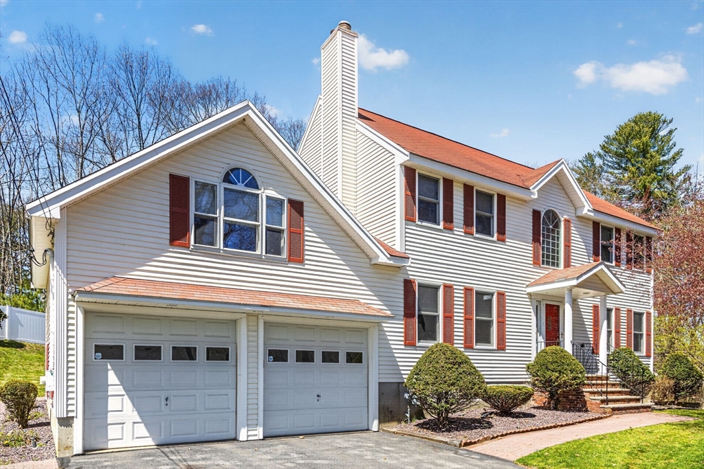 22 McRayne Hill Road Billerica, MA 01821 - Photo 3 of 42 a front view of a house with yard and garage